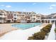 Community pool surrounded by townhomes and light dusting of snow at 10511 Sablewood Dr # 110, Raleigh, NC 27617