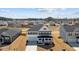 Aerial view of a two-story home in a suburban neighborhood with a spacious yard and blue skies at 107 Barn Door Dr, Lillington, NC 27546