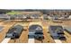 Aerial view of white home with black roof and shutters in a newly developed neighborhood at 107 Barn Door Dr, Lillington, NC 27546