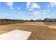 Backyard with a freshly seeded lawn and concrete patio at 107 Barn Door Dr, Lillington, NC 27546