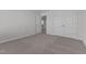 Bedroom with plush carpet, neutral walls, and double door closet at 107 Barn Door Dr, Lillington, NC 27546