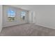 Bedroom with plush carpet, neutral walls, and view of the neighborhood at 107 Barn Door Dr, Lillington, NC 27546