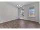 Elegant dining room featuring hardwood floors, a modern chandelier, and bright natural light at 107 Barn Door Dr, Lillington, NC 27546