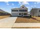 Charming two-story home with a covered front porch, black shutters, and a well-manicured lawn at 107 Barn Door Dr, Lillington, NC 27546
