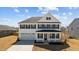 Charming two-story home featuring a covered porch, a two car garage, and a well maintained yard at 107 Barn Door Dr, Lillington, NC 27546