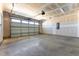 Unfinished two car garage with garage door, drywall, and concrete floor at 107 Barn Door Dr, Lillington, NC 27546