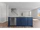 Spacious kitchen showcasing a center island with stainless steel dishwasher, white countertops, and natural lighting at 107 Barn Door Dr, Lillington, NC 27546