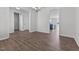 Open-concept living area with hardwood floors, modern lighting, and seamless flow into the kitchen at 107 Barn Door Dr, Lillington, NC 27546
