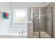 Bathroom with soaking tub and a walk-in shower at 117 Sunburst Ct, Fuquay Varina, NC 27526