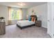 Cozy bedroom with gray bed frame, wood nightstands, and large window at 117 Sunburst Ct, Fuquay Varina, NC 27526