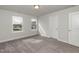 Bright bedroom with two windows, neutral walls, and carpet flooring at 117 Sunburst Ct, Fuquay Varina, NC 27526
