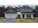 Two-story house with gray and yellow siding, white garage door, and landscaping at 117 Sunburst Ct, Fuquay Varina, NC 27526