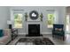 Spacious living room with a cozy fireplace and large windows at 117 Sunburst Ct, Fuquay Varina, NC 27526