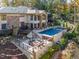 Breathtaking aerial view showcasing the estate's expansive backyard, pool, fire pit, and lush landscaping at 12044 Iredell, Chapel Hill, NC 27517