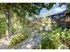 Beautifully landscaped backyard with a stone pathway leading to an outdoor living area with a sunroom at 12044 Iredell, Chapel Hill, NC 27517