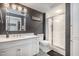 Modern bathroom with dark accent wall, white vanity, marble countertops, and a glass-enclosed shower at 12044 Iredell, Chapel Hill, NC 27517