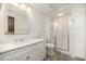 Well-lit bathroom with a glass shower, marble countertop, and white cabinets offering plenty of storage space at 12044 Iredell, Chapel Hill, NC 27517