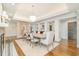 Formal dining room featuring a large table, stylish chandelier, and decorative mirror at 12044 Iredell, Chapel Hill, NC 27517