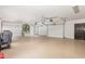 Spacious two-car garage with epoxy flooring, built-in shelving, and natural light from an arched window at 12044 Iredell, Chapel Hill, NC 27517
