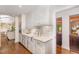 Charming kitchen featuring white cabinets, tile backsplash, and modern stainless-steel appliances at 12044 Iredell, Chapel Hill, NC 27517