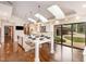A bright, spacious kitchen featuring a large island with skylights above and a sliding glass door at 12044 Iredell, Chapel Hill, NC 27517
