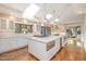 Gourmet kitchen features white cabinetry, stainless appliances, and a center island with seating at 12044 Iredell, Chapel Hill, NC 27517
