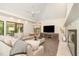 Bright living room featuring a fireplace, neutral décor, and large windows offering natural light at 12044 Iredell, Chapel Hill, NC 27517