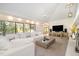 Spacious living room featuring a white sectional sofa, large TV, and a cozy fireplace at 12044 Iredell, Chapel Hill, NC 27517