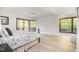 Light-filled main bedroom with hardwood floors, views of trees, a ceiling fan, and sliding glass door access at 12044 Iredell, Chapel Hill, NC 27517