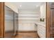 Walk-in pantry with ample storage including shelves and drawers, plus a stainless steel refrigerator at 12044 Iredell, Chapel Hill, NC 27517