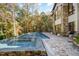 Beautiful backyard featuring a pristine pool, hot tub, and a brick patio perfect for entertaining and relaxation at 12044 Iredell, Chapel Hill, NC 27517