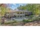A luxurious home exterior featuring a private pool, landscaped grounds, and outdoor lounge areas at 12044 Iredell, Chapel Hill, NC 27517