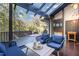 Inviting sunroom featuring comfortable seating, a glass ceiling, and access to a deck with scenic views at 12044 Iredell, Chapel Hill, NC 27517