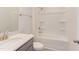 Bathroom with white bathtub, shower, and gray vanity at 121 Barn Door Dr, Lillington, NC 27546