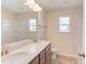 Bathroom with double vanity, quartz countertop, and a large mirror at 121 Barn Door Dr, Lillington, NC 27546