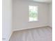 Bright bedroom with large window and carpet flooring at 121 Barn Door Dr, Lillington, NC 27546