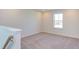 Upstairs bedroom with carpeted floor and a window at 121 Barn Door Dr, Lillington, NC 27546