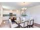 Bright dining area with glass table and chairs, adjacent to kitchen at 121 Barn Door Dr, Lillington, NC 27546