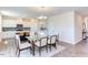 Bright dining area with glass table and chairs, adjacent to kitchen at 121 Barn Door Dr, Lillington, NC 27546