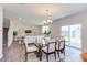 Spacious dining area with glass top table and chairs, adjacent to living room at 121 Barn Door Dr, Lillington, NC 27546