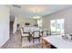 Bright dining room with glass table and seating for six, open to living area at 121 Barn Door Dr, Lillington, NC 27546