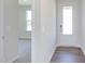 Bright entryway with white door and gray vinyl plank flooring at 121 Barn Door Dr, Lillington, NC 27546