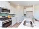 Modern kitchen with white cabinets, stainless steel appliances, and an island at 121 Barn Door Dr, Lillington, NC 27546