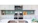 Modern kitchen with white cabinets, stainless steel appliances, and quartz countertops at 121 Barn Door Dr, Lillington, NC 27546