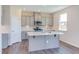 Modern kitchen with gray cabinets, white countertop island, and herringbone backsplash at 121 Barn Door Dr, Lillington, NC 27546