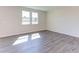 Spacious living room with gray vinyl plank flooring and lots of natural light at 121 Barn Door Dr, Lillington, NC 27546