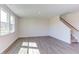 Bright living room with gray vinyl plank flooring and natural light at 121 Barn Door Dr, Lillington, NC 27546