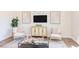 Living room with two armchairs, a coffee table and hardwood floors at 121 Barn Door Dr, Lillington, NC 27546