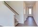 Staircase with carpeted steps and wooden handrail at 121 Barn Door Dr, Lillington, NC 27546