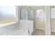 Bathroom boasts marble shower, soaking tub, and large window at 128 Baird Cv Ln, Angier, NC 27501